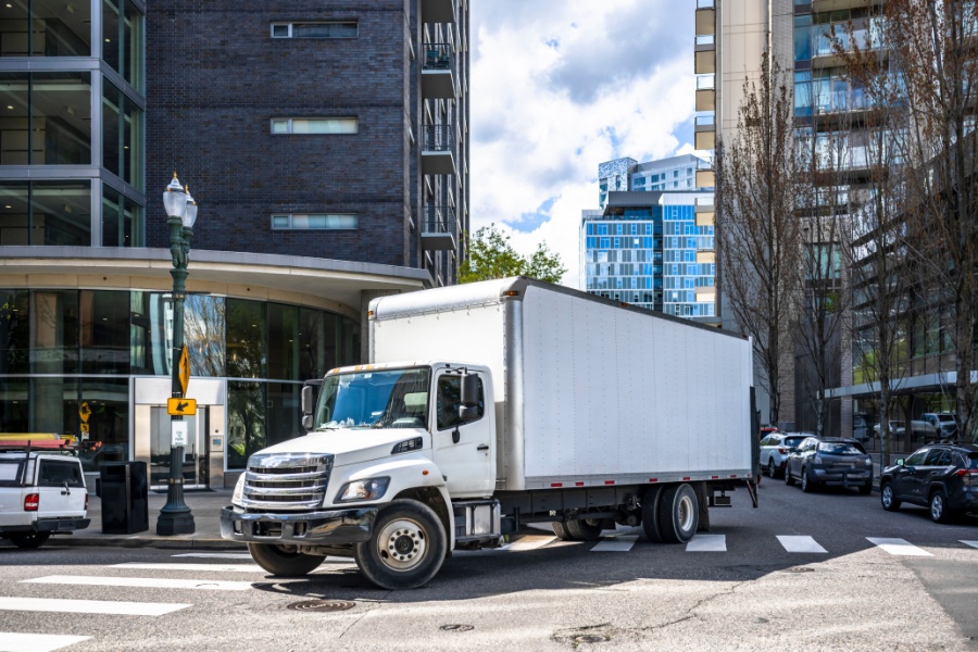 White box truck making a delivery in a metro area