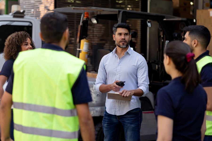 supply chain manager talking with workers