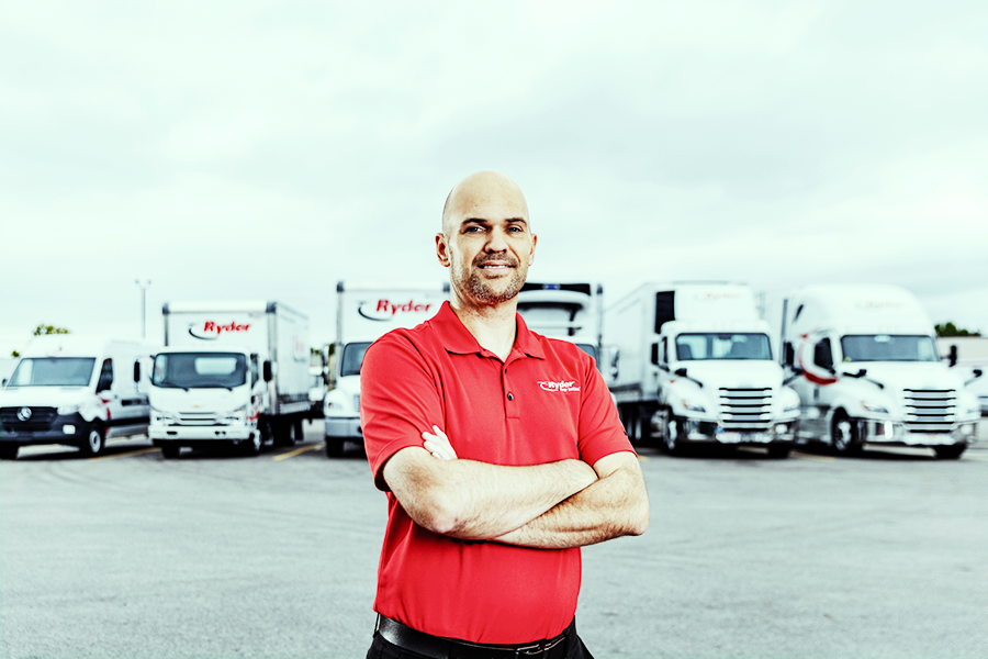 ryder employee standing in front of lease vehicles