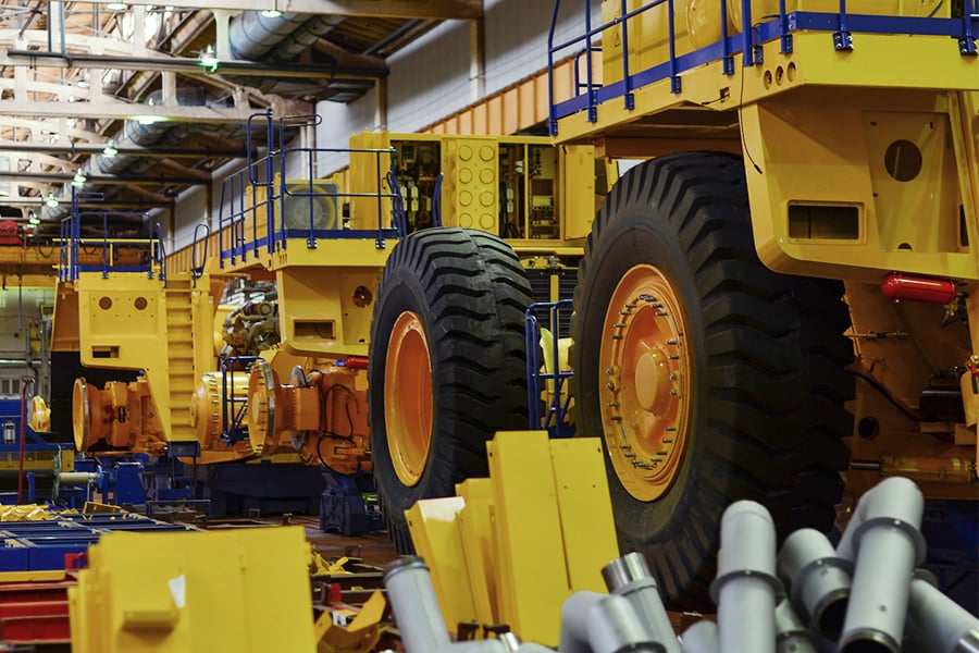 Heavy equipment being assembled in a manufacturing facility