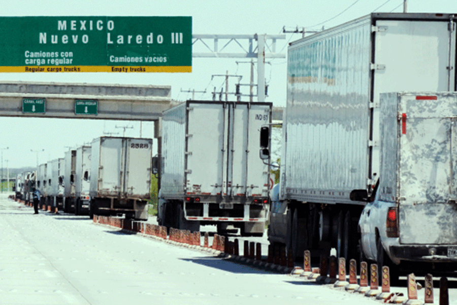 line of trucks transporting freight cross border